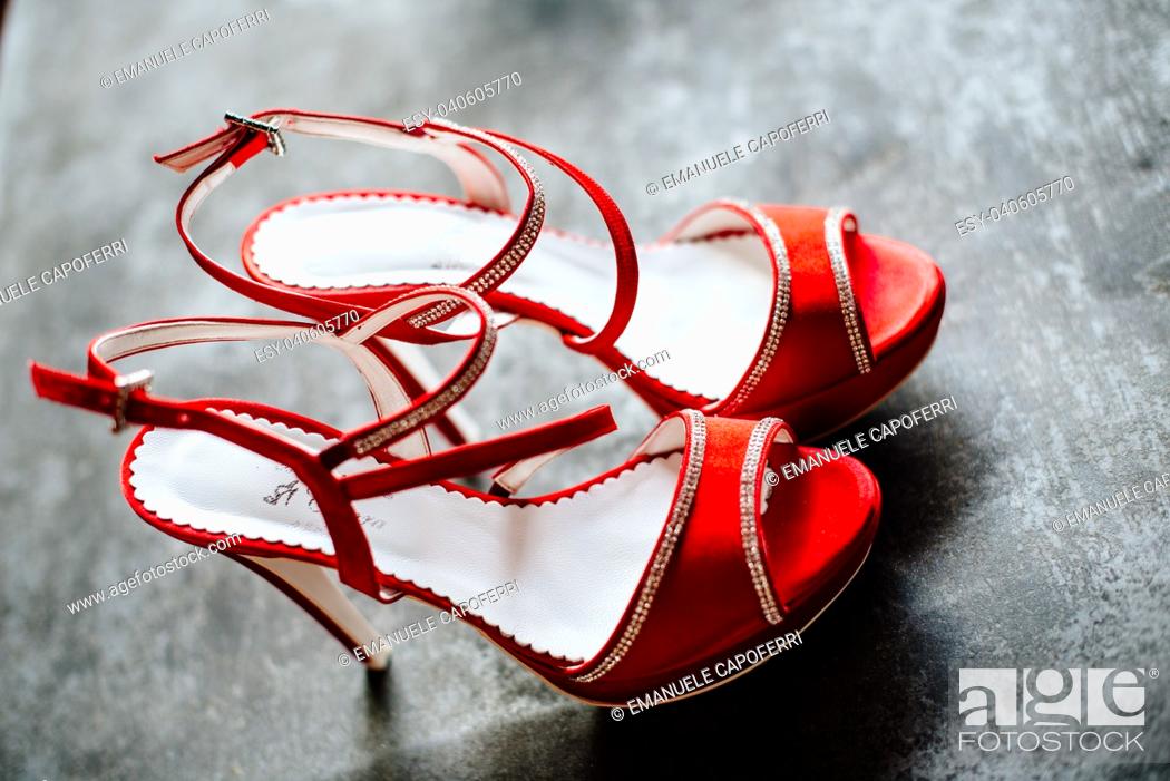 Stock Photo: elegant red bride's wedding shoes.