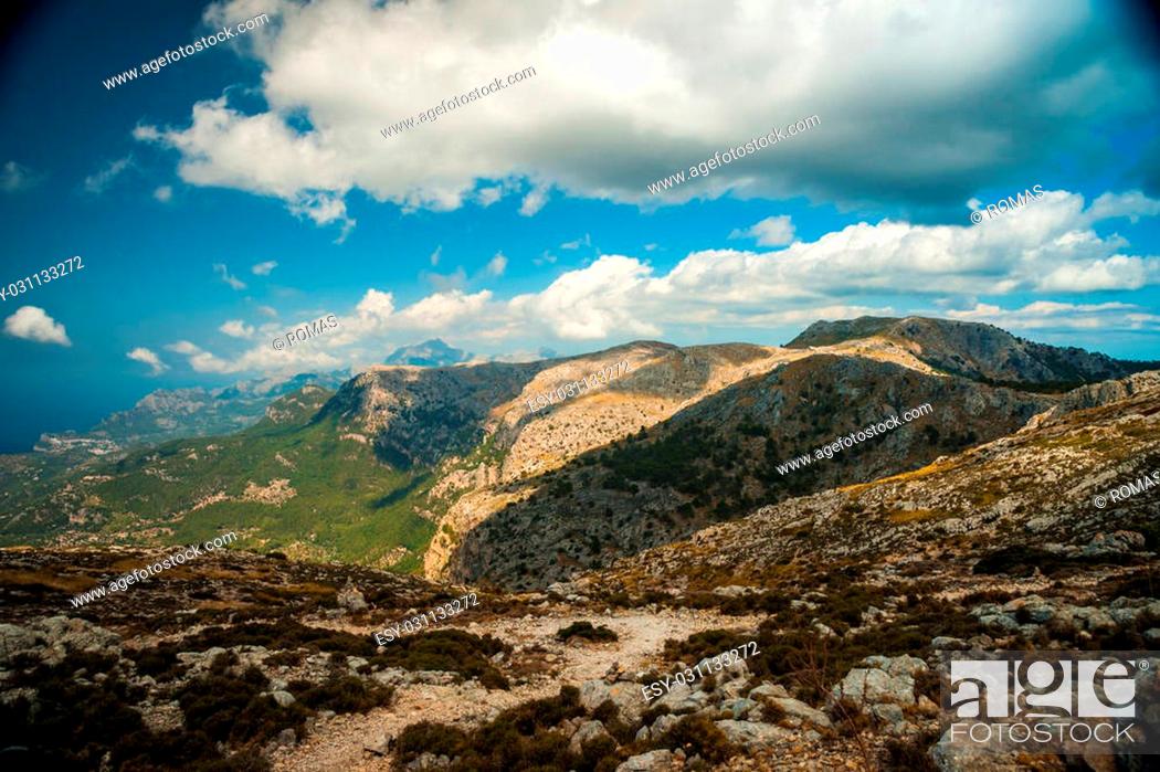 Stock Photo: Beautiful landscape view of rocky mountains and clouds on the western part of Mallorca island, Spain. Tramuntana mountains with blue sea in background.