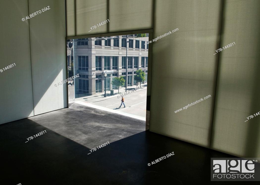 Stock Photo: Hole in the window where the pedestrian is crossing an empty street in Denver.