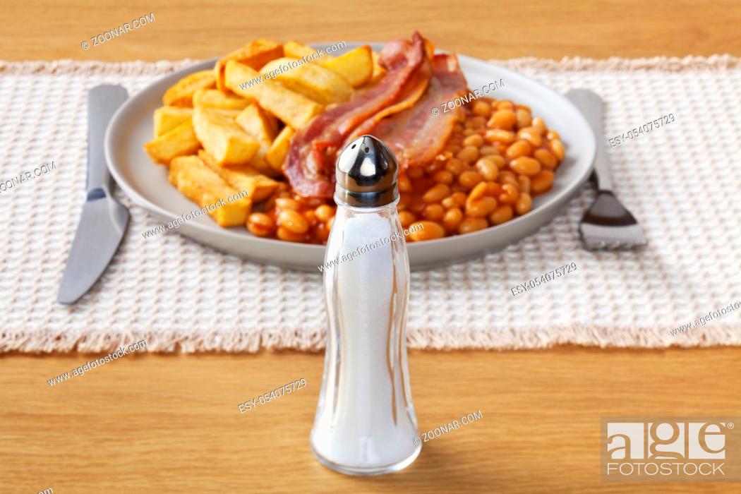 Stock Photo: Salt and Fried Food - salt and a typical high salt, high fat meal of chips, bacon and baked beans.