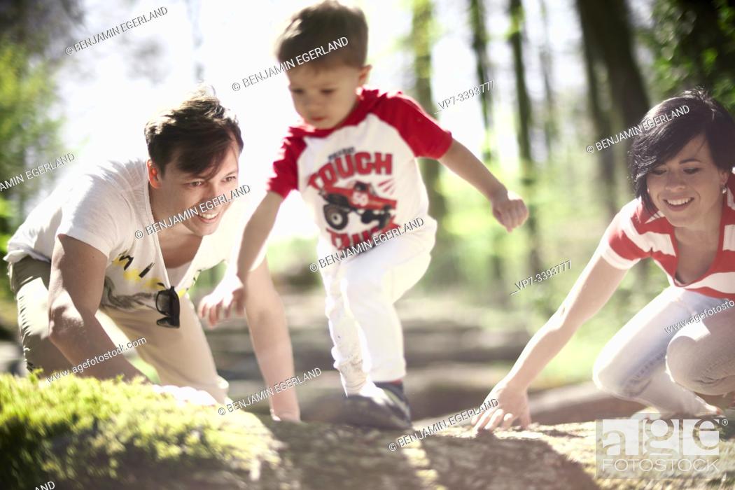 Stock Photo: toddler child with parents in forest, at Herrenchiemsee, Chiemsee, Bavaria, Germany.