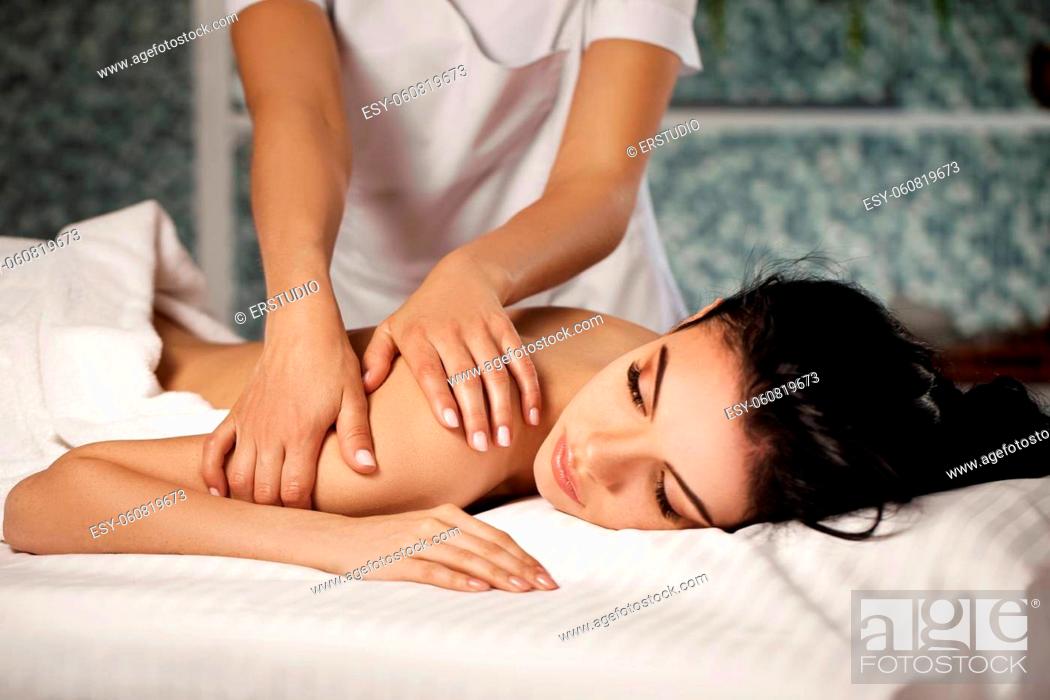 Stock Photo: Relaxed beautiful young woman receiving massage in spa salon. Beauty treatment.