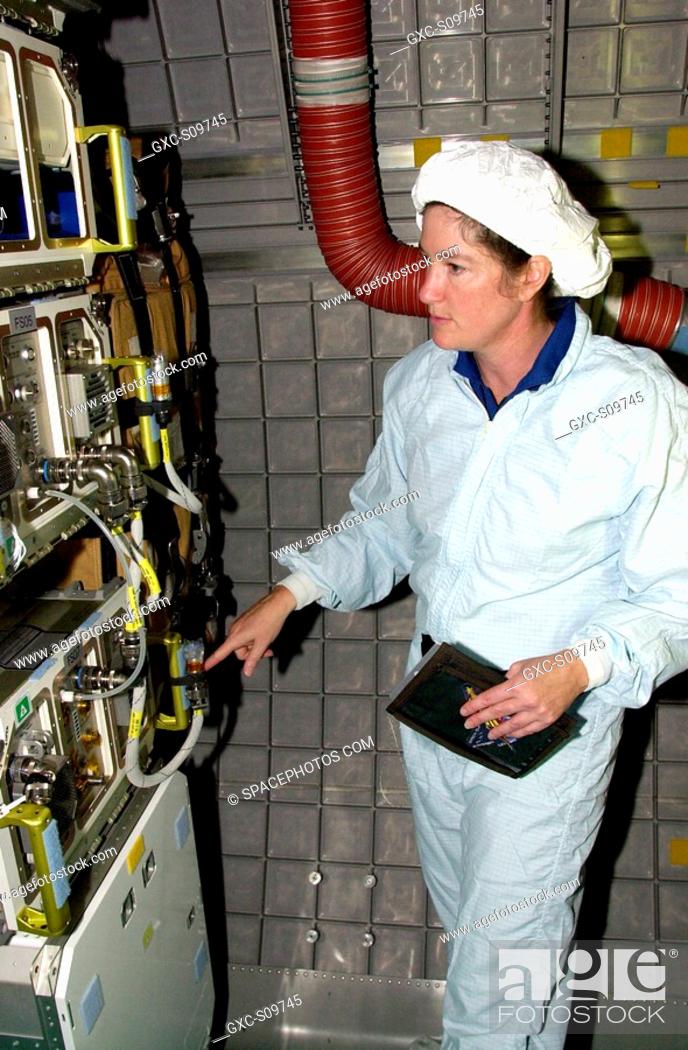 Stock Photo: 06/08/2002 - STS-107 Mission Specialist Laurel Clark looks over experiments equipment in the SHI Research Double Module SHI/RDM.
