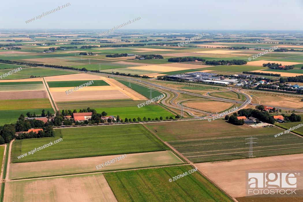 Stock Photo: Aerial view Dutch agricultural landscape with farmhouses and a highway.