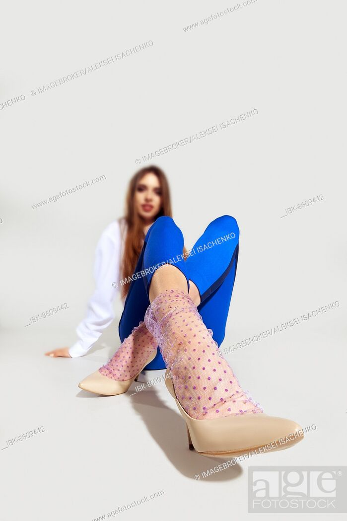 Stock Photo: Cute girl in tulle socks on gray background.