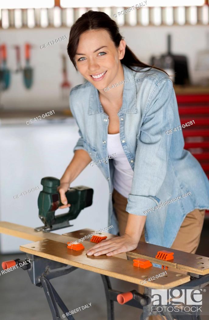 Stock Photo: Woman working in workshop.