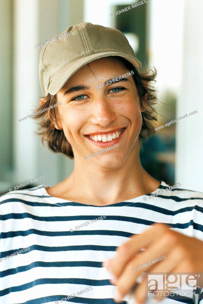 Stock Photo: Toothy Smile, Looking At Camera, Outdoors, Front View, Teenage Boy Only, Teenagers Only, Only, One, Portrait, Vertical, Happy, Positive, Smile, Laughing, Cap, Teenager, Friendly, Boy, Color Image, One Person, Optimism
