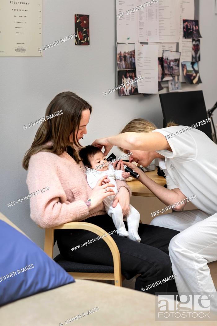 Stock Photo: Doctor checking baby's temperature.