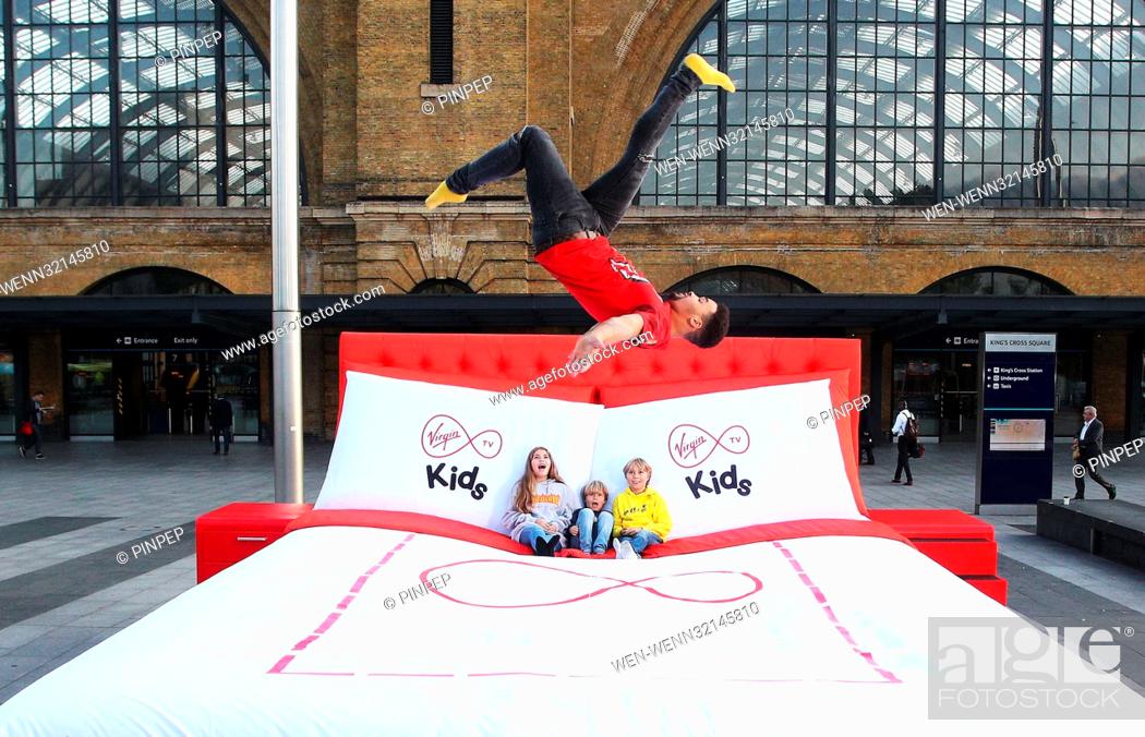 Stock Photo: FREE FOR EDITORIAL USE Morning commuters were treated to a surprise today in London, seeing kids of all ages jumped for joy on Virgin TV”s giant 15 square metre.