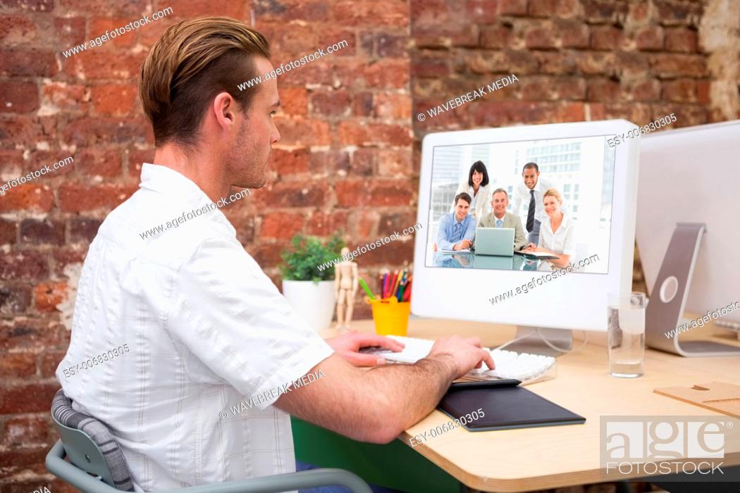 Stock Photo: Composite image of happy business people gathered around laptop looking at camera.