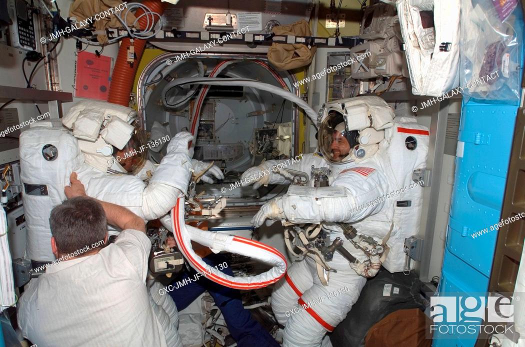 Stock Photo: Attired in their Extravehicular Mobility Unit (EMU) spacesuits, European Space Agency (ESA) astronaut Hans Schlegel (left) and NASA astronaut Rex Walheim.