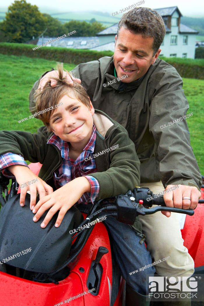 Stock Photo: Father and son on quad bike.