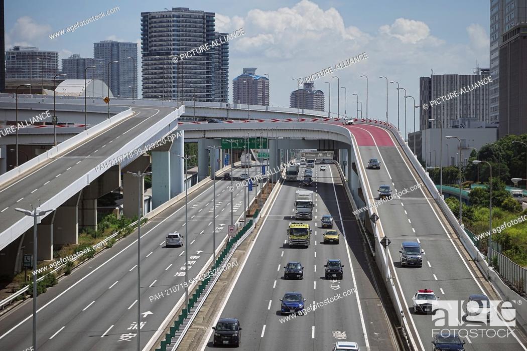 Stock Photo: 18 July 2021, Japan, Tokio: Cars drive over multi-lane roads and overpasses. The 2020 Tokyo Olympics will be held from 23.07.2021 to 08.08.2021.