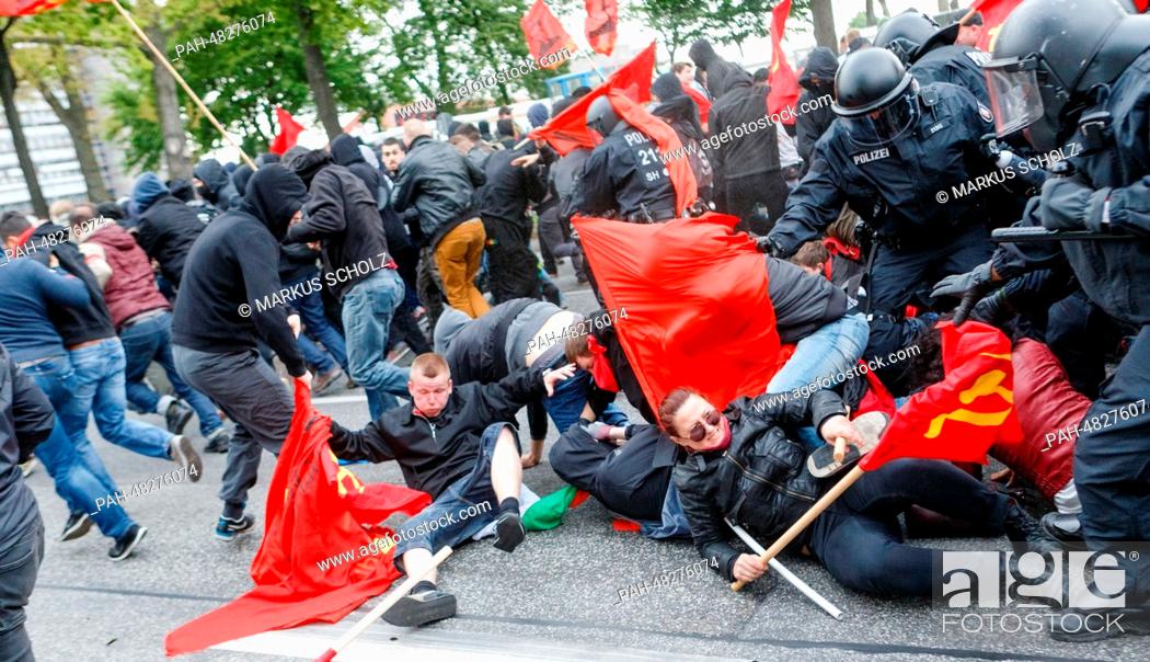 Stock Photo: Police officers stop demonstrators and force them onto a shortened route during the May Day demonstration in Hamburg, Germany, 01 May 2014.
