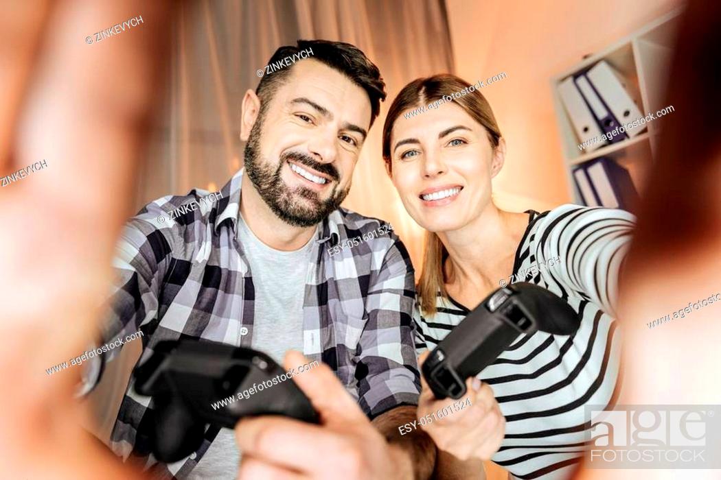 Stock Photo: Keep smiling. Cheerful couple expressing positivity and touching camera while looking forward.
