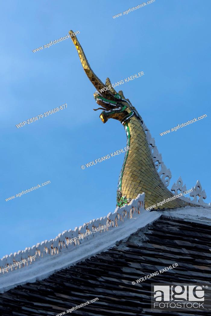 Stock Photo: Detail of the roof which is adorned with stylized Naga finials at the roof?s ends on Wat Wisunalat which is the oldest temple in the UNESCO world heritage town.