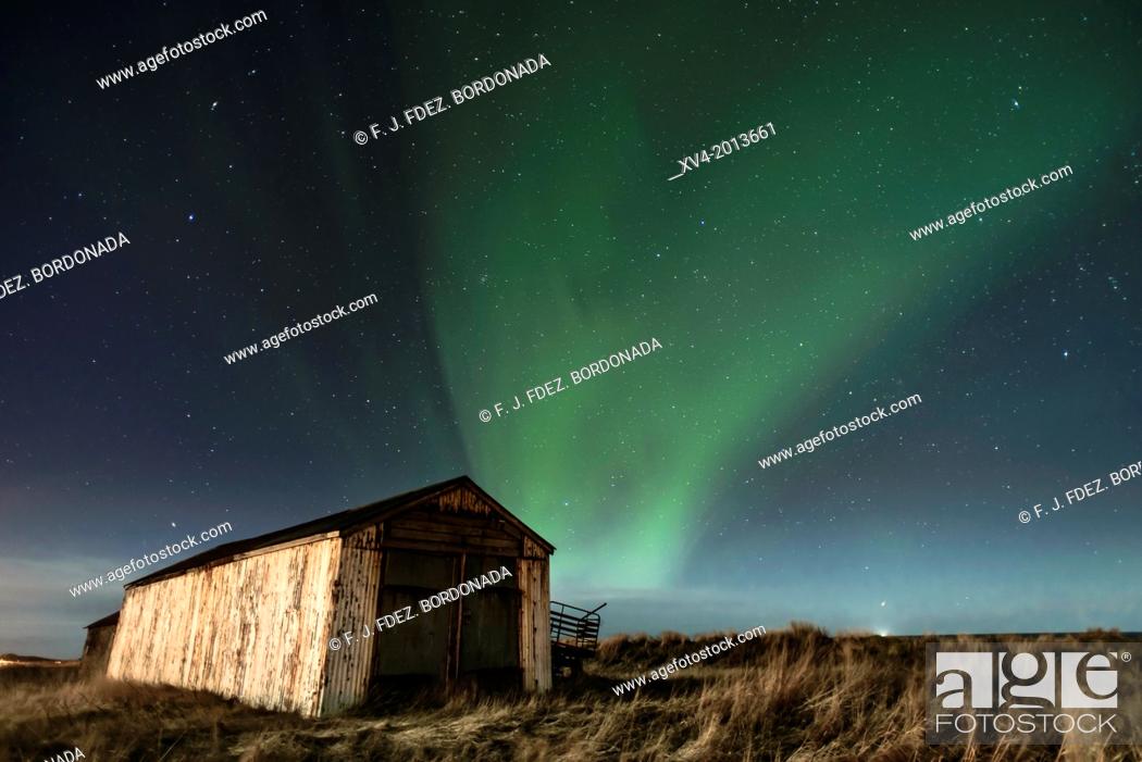 Stock Photo: Warehouse with Aurora Borealis background, Northern lights in winter. Southern Iceland.