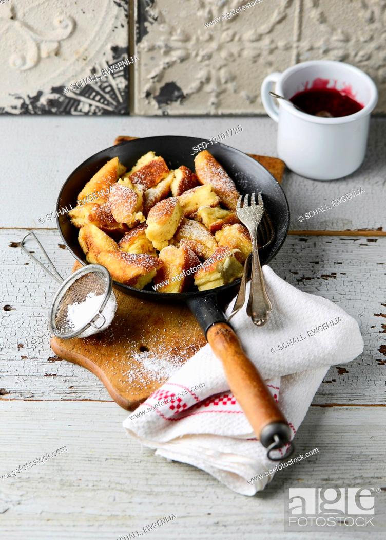 Stock Photo: Kaiserschmarren (sweet cut up pancakes) with cherry compote.