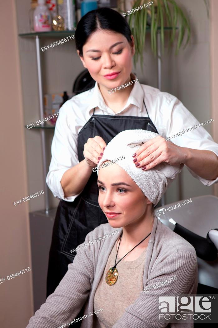 Stock Photo: Beautiful lady sitting inchair after having her hair washed in hairdressing saloon. Barber girl preparing hair for haircut.