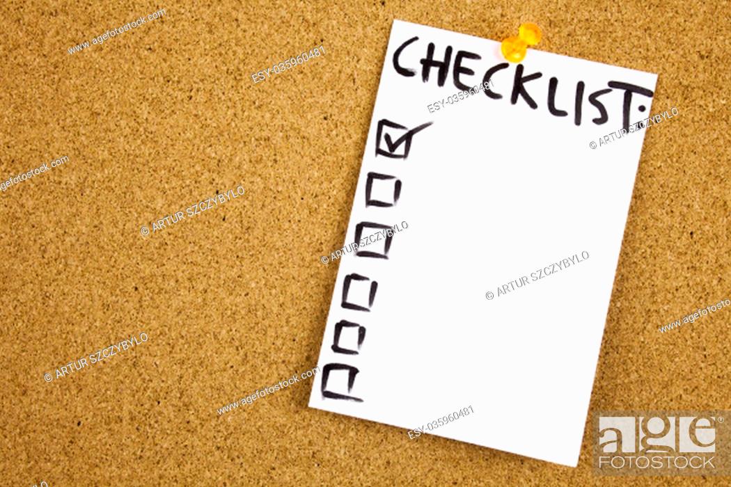 Stock Photo: A yellow sticky note writing, caption, inscription Checklist on colorful sticky note in black ext on a sticky note pinned.