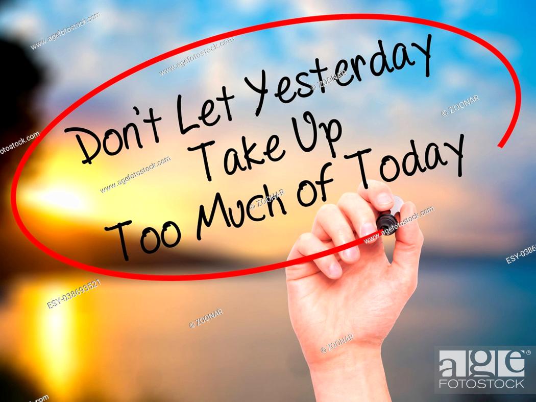 Stock Photo: Man Hand writing Don't Let Yesterday Take Up Too Much of Today with black marker on visual screen.
