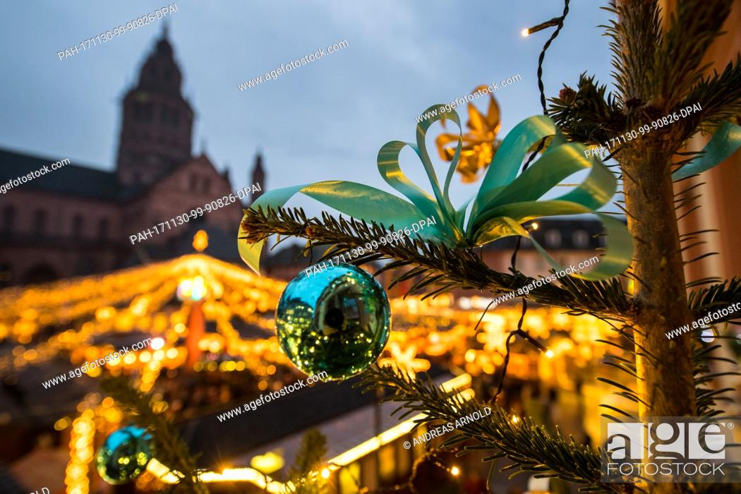 Stock Photo: dpatop - A Christmas tree shines in the night during the opening of the Christmas market in Mainz, Germany, 30 November 2017.