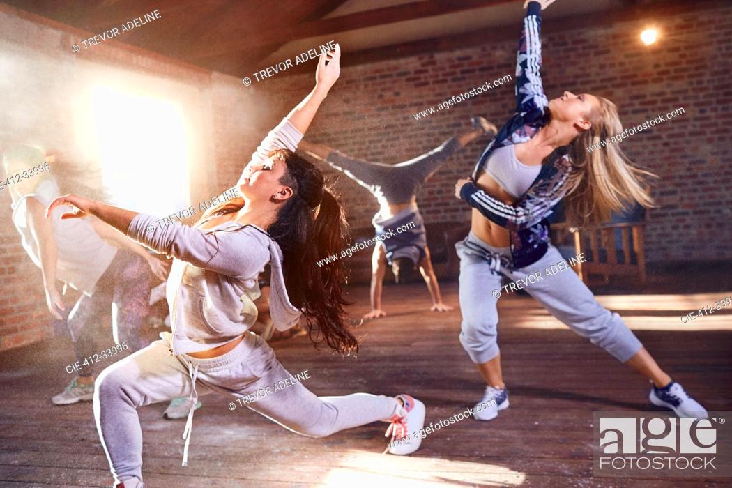 Stock Photo: Young hip hop dancers with powder dancing in studio.