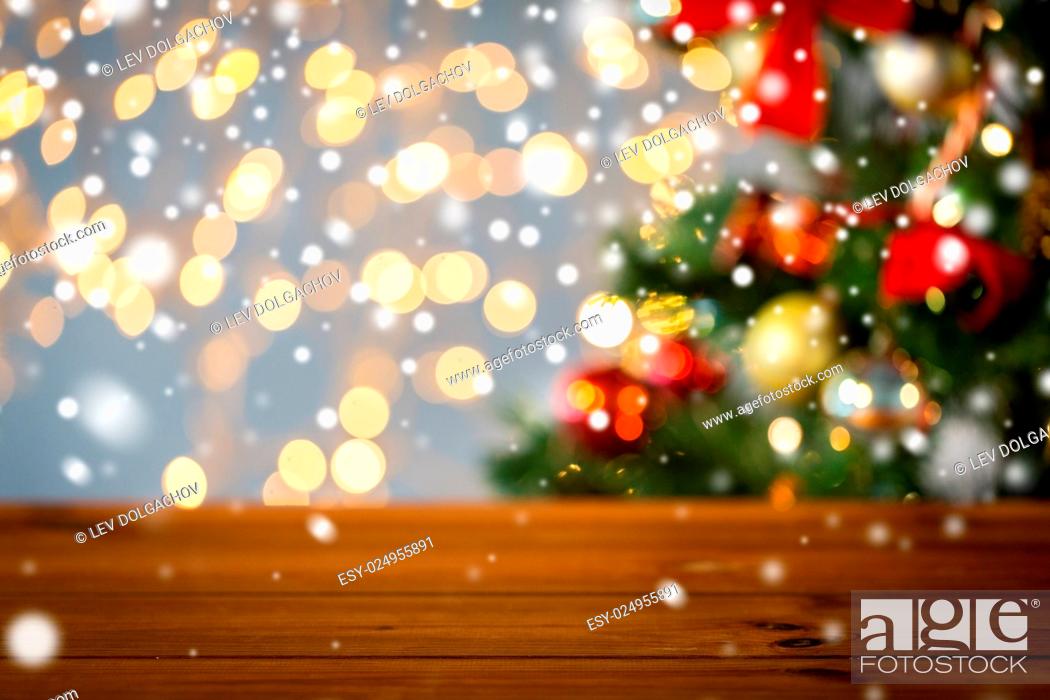 Stock Photo: holidays, new year and celebration concept - close up of empty wooden surface or table over christmas tree and lights background.