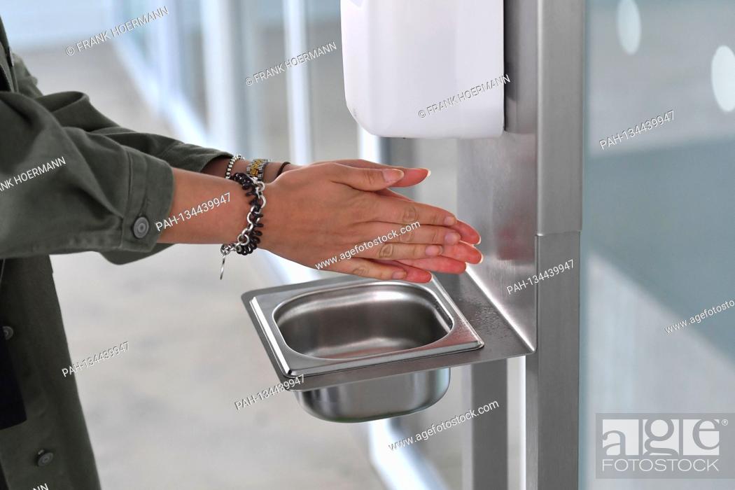 Stock Photo: Hand disinfection at Albrecht Duerer Airport in Nuernberg on August 1st, 2020. Hygiene measure, hand cleaning, disinfect hands. Disinfection switch.
