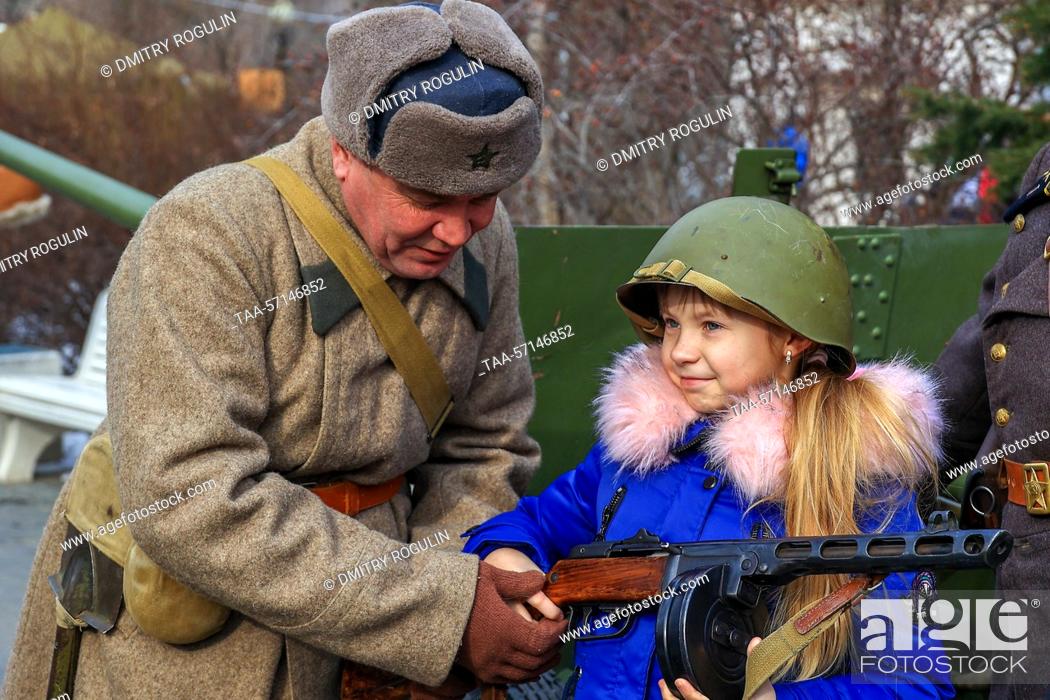 Stock Photo: RUSSIA, VOLGOGRAD - FEBRUARY 2, 2023: A participant in a historical reenactment and a girl are seen during a celebration of the 80th anniversary of the victory.