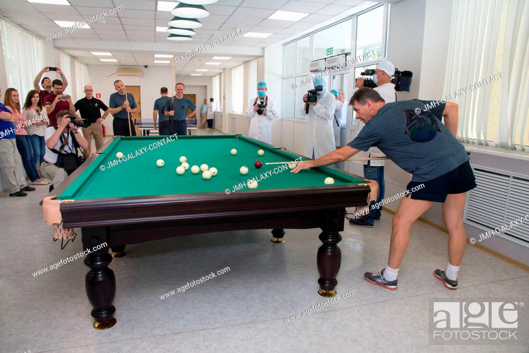 Stock Photo: At the Cosmonaut Hotel crew quarters in Baikonur, Kazakhstan, Expedition 52-53 crewmember Paolo Nespoli of the European Space Agency tries his hand at billiards.