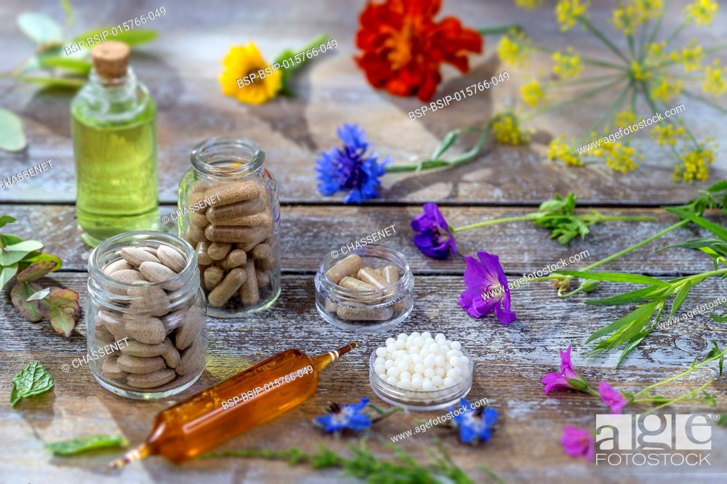 Stock Photo: Alternative herb medicine. herbal vitamin on wooden board.