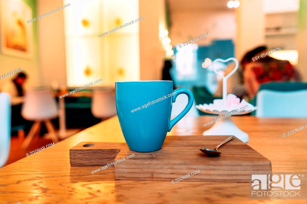 Stock Photo: Hot cappuccino coffee in coffee shop on wooden table, close angle.