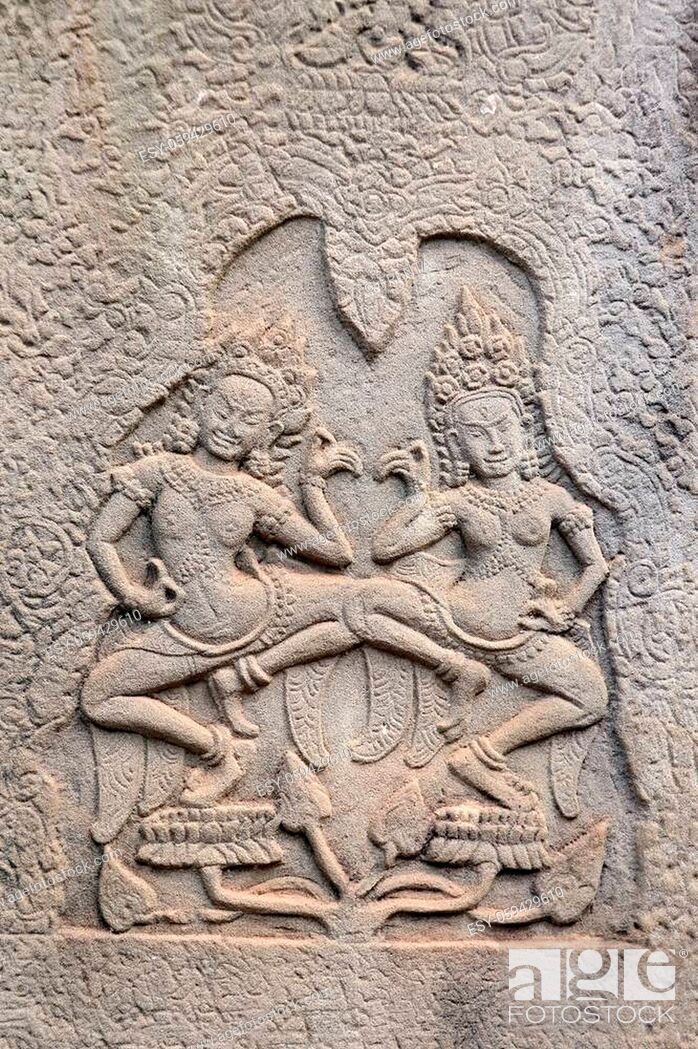Stock Photo: Wall carving with two womans - dancers apsara, Prasat Bayon Temple, famous Angkor Wat complex, khmer culture, Siem Reap, Cambodia.