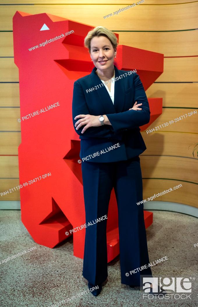 Stock Photo: 30 November 2021, Berlin: Franziska Giffey, chairwoman of the Berlin SPD and designated governing mayor of Berlin, stands in front of a red bear during an.