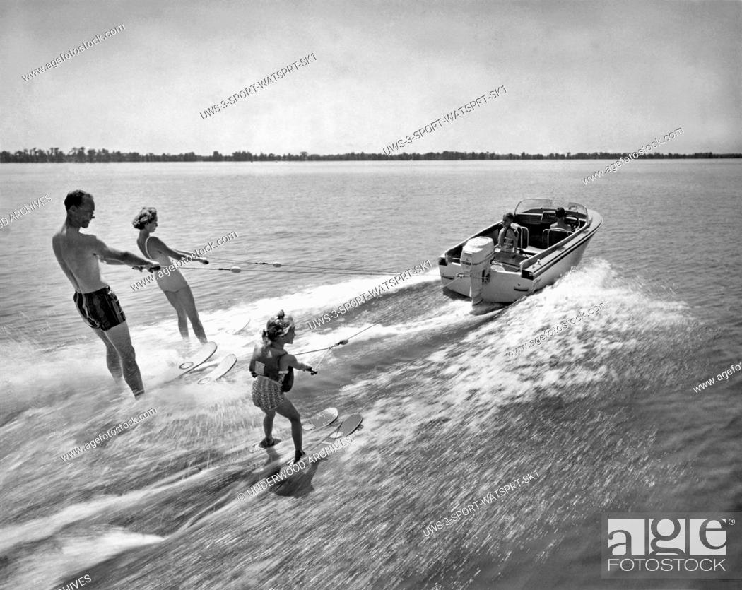 Stock Photo: Cypress Gardens, Florida: 1959.The whole family enjoys water skiing behind a Johnson Super Sea-Horse 35hp motor.