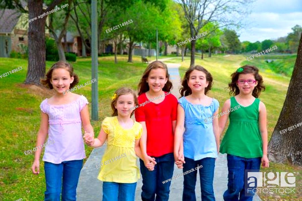 Stock Photo: Children group of sisters girls and friends walking in park.