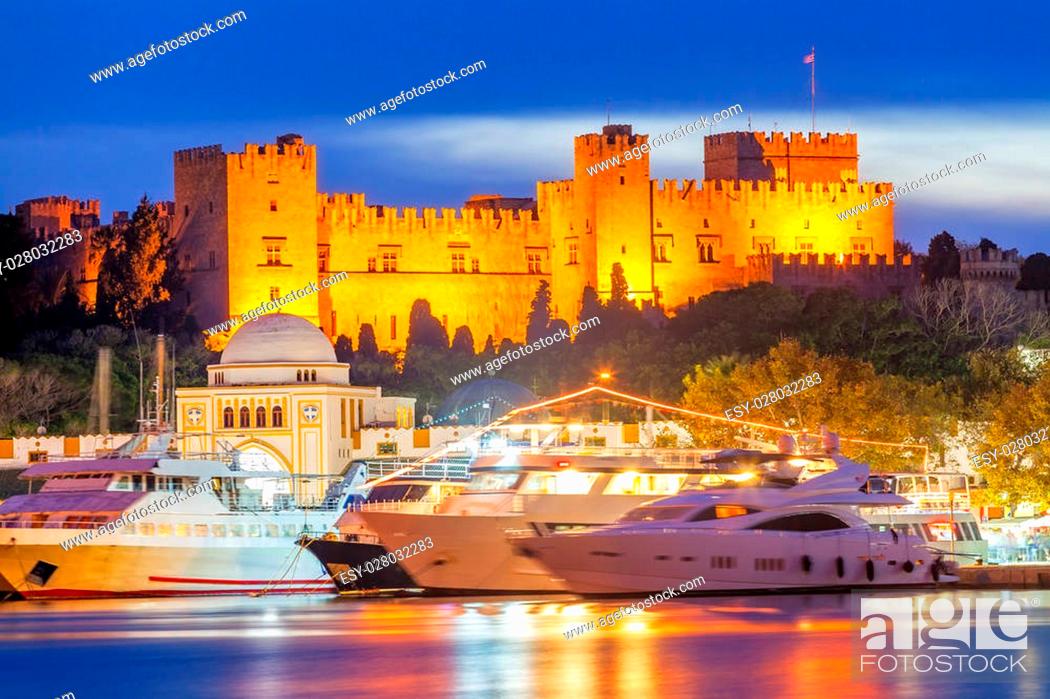 Stock Photo: Mandraki Harbour Rhodes Greece and The Palace of the Grand Master of the Knights of Rhodes at night.