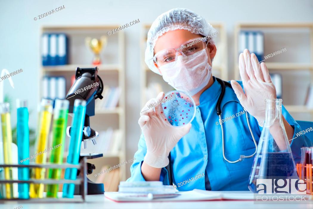 Stock Photo: Female scientist researcher doing experiments in laboratory.