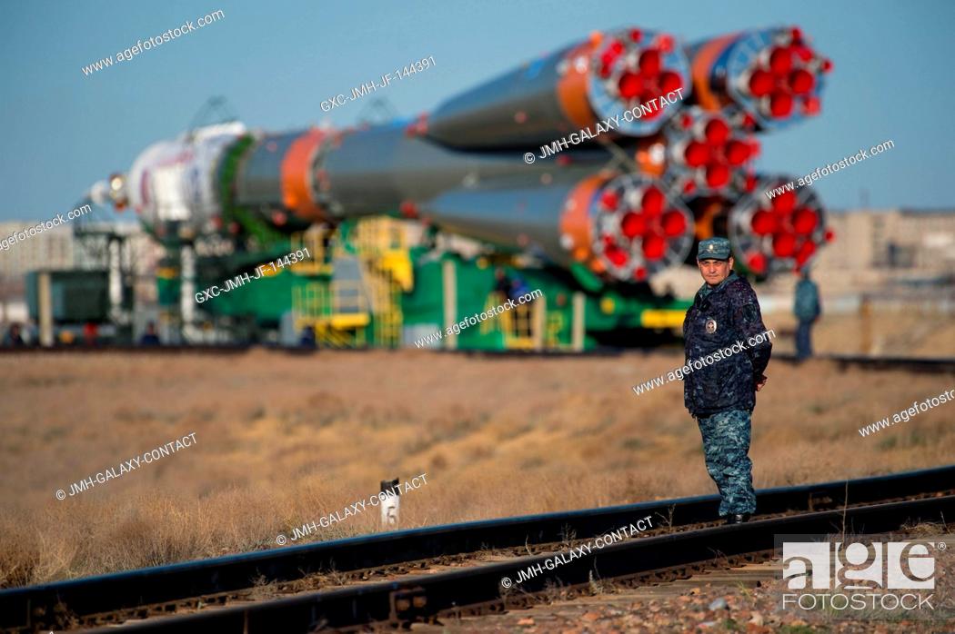Stock Photo: A Russian security officer is seen as the Soyuz MS-04 spacecraft is rolled out to the launch pad by train on Sunday, April 16.
