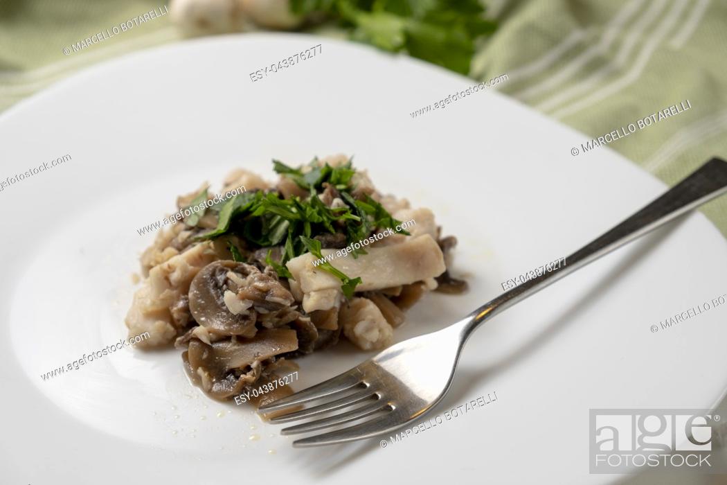 Stock Photo: fillet of perch with champignon mushrooms and parsley on white plate.