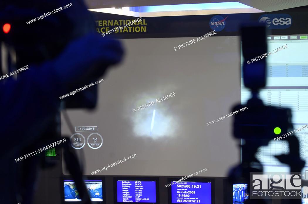 Stock Photo: 11 November 2021, Bavaria, Oberpfaffenhofen: A Falcon 9 rocket from SpaceX in flight can be seen on a large video screen in the Columbus Control Center at the.
