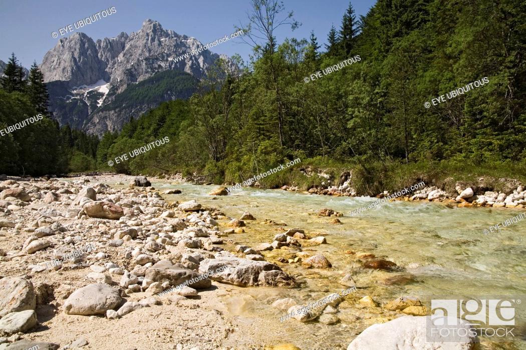 Stock Photo: Looking along the Velika Pisnica towards Mount Prisank in the Julian Alps. There is still snow lying on the mountain after a severe winter.