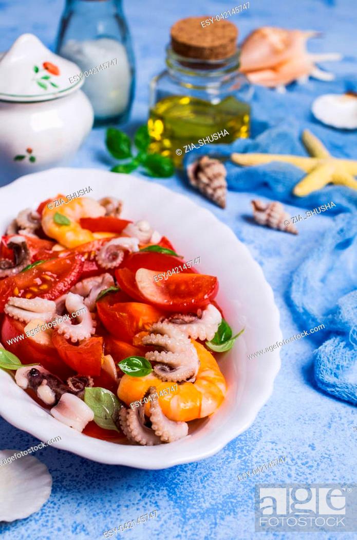 Stock Photo: Salad with seafood and vegetables in a plate on the table. Selective focus.