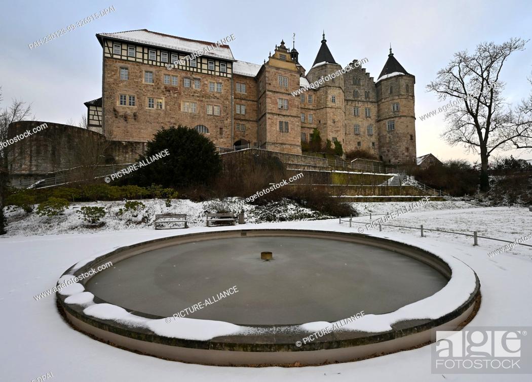 Stock Photo: 23 January 2023, Thuringia, Schleusingen: Snow lies in the castle garden of Schloss Bertholdsburg. Extensive restoration work is currently being prepared by.