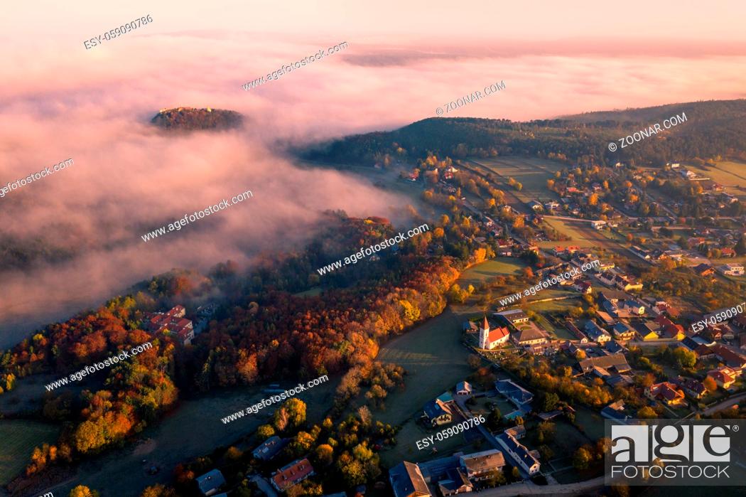Stock Photo: Small town village during the sunrise with fog. surrounded by hills in lower austria. Aerial drone photo in autumn.