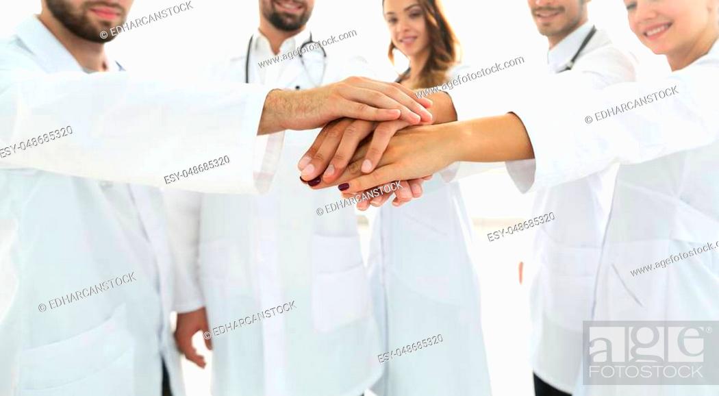 Stock Photo: Doctors and nurses in a medical team stacking hands.concept of teamwork.