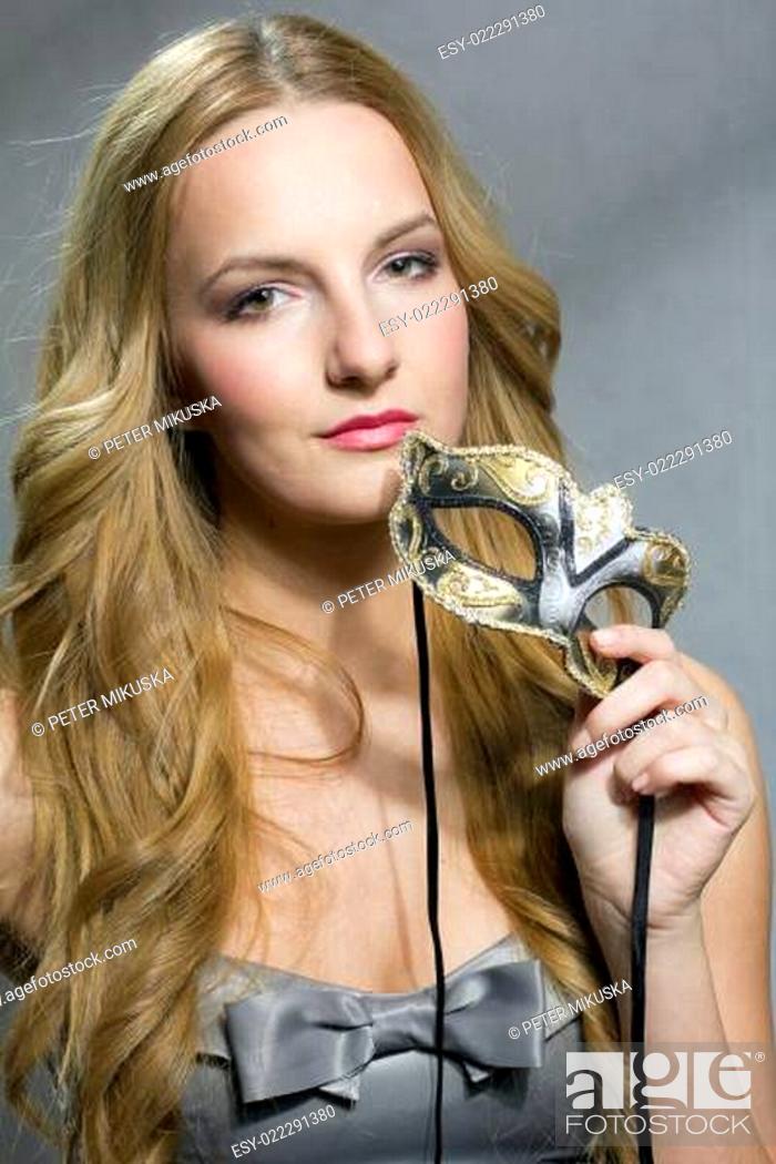 Stock Photo: Woman holding a mask.