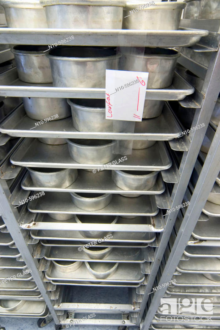 Stock Photo: Empty cake pans on a rack with an attached note reading 'Low Fat'.