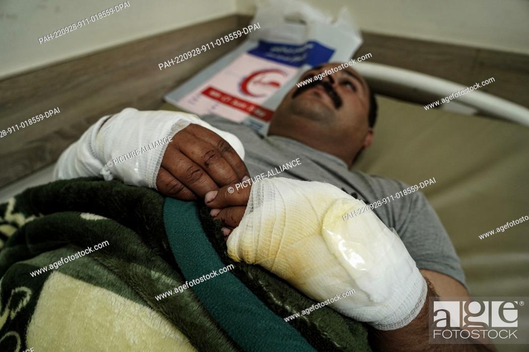 Stock Photo: 28 September 2022, Iraq, Erbil: A wounded member of the opposition Kurdistan Freedom Party (PAK) lies on a bed at a hospital following attacks by Iranian.